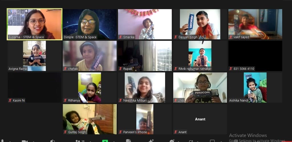 Children showing their workshop kits during an online session