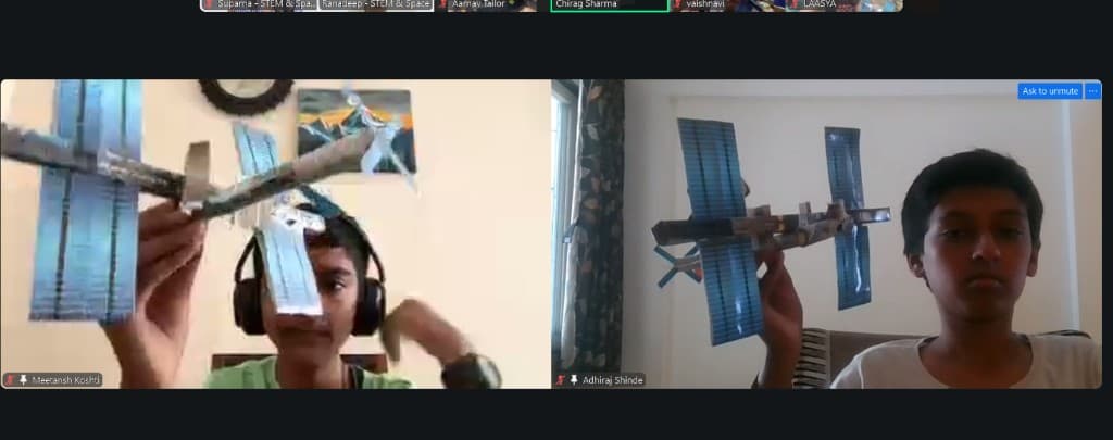 Children showing space-station models on a live video call